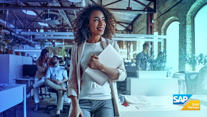 happy woman carrying tablet in office